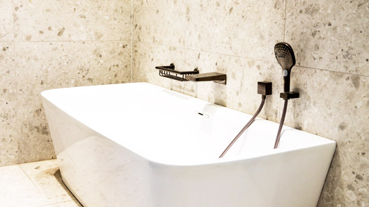 Bathroom remodel soaking bathtub and wall-mounted faucet installation in Milwaukee, Wisconsin